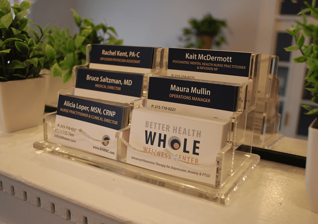 Better Health Whole Wellness Center clinical team business cards in front office showing Alicia Loper MSN CRNP Bruce Saltzman MD Rachel Kent PA-C Kait McDermott NP and Maura Mullin at Rittenhouse Square Philadelphia ketamine therapy practice